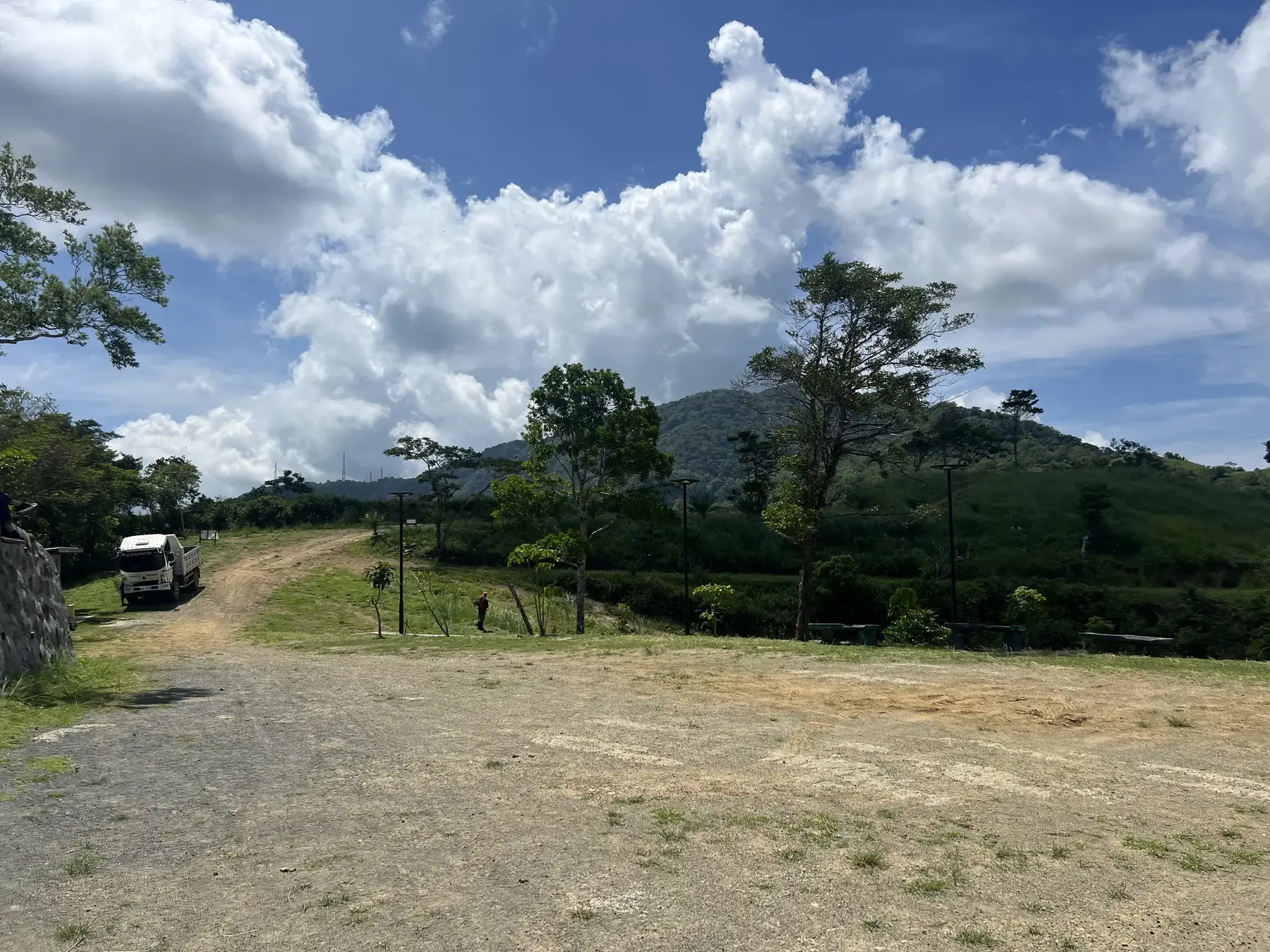 Site development underway at Sto. Domingo Highlands, with a work truck on the access road